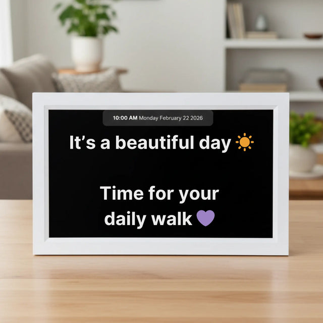 Memoryboard 15-inch digital message board displaying “It’s a beautiful day ☀️ Time for your daily walk 💜” with date and time shown at the top.