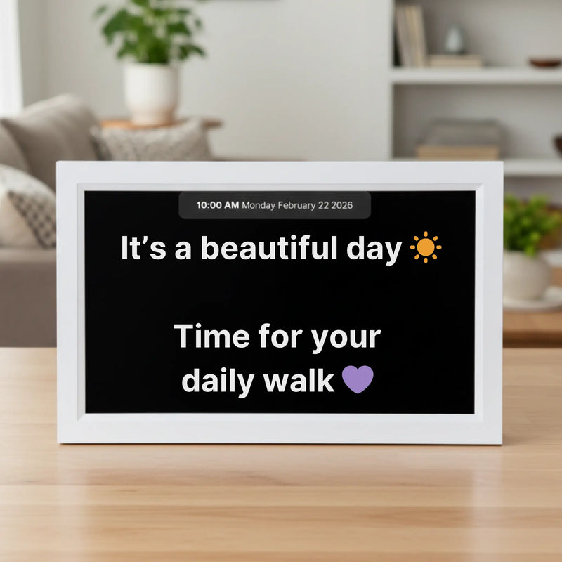 Memoryboard 15-inch digital message board displaying “It’s a beautiful day ☀️ Time for your daily walk 💜” with date and time shown at the top.