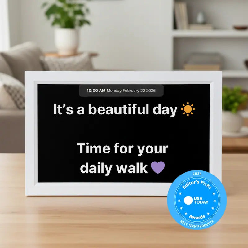 Memoryboard 15-inch digital message board displaying “It’s a beautiful day ☀️ Time for your daily walk 💜” with date and time shown at the top.