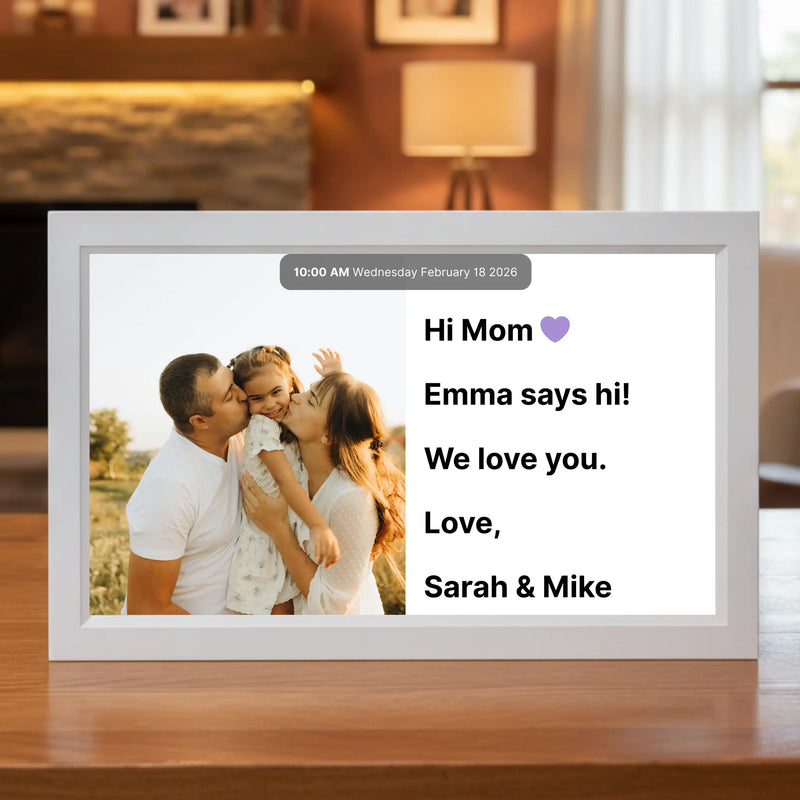 15 inch Memoryboard digital display on a table showing a family photo and a message that reads “Hi Mom 💜 Emma says hi! We love you. Love, Sarah & Mike.”